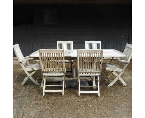 A teak slatted extending garden table, 205 x 100cm overall, together with six teak chairs