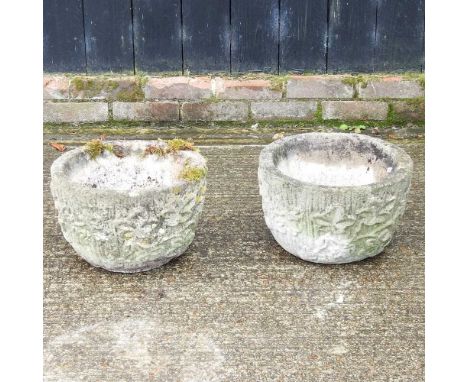 A pair of weathered cast stone garden planters