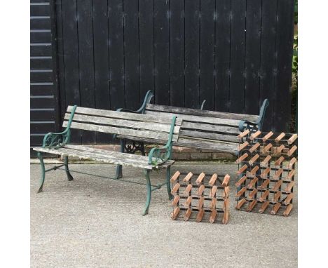 A cast and wrought iron garden bench, 129cm wide, together with another and two wine racks (4)