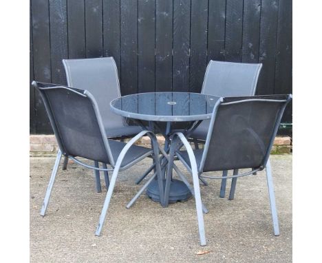 A modern garden patio set, comprising a glass top table and four armchairs88cm diameter x 72h