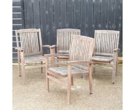 A near set of four teak garden armchairs