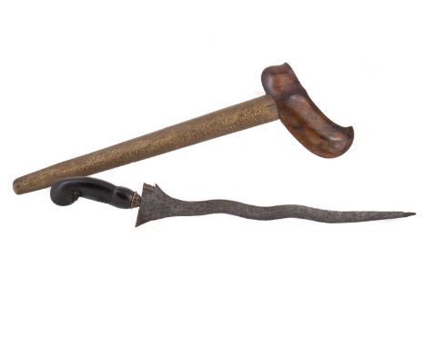 INDONESIAN KRIS 19TH CENTURY with the waved steel blade over a carved hardwood grip, in hardwood mounted embossed brass scabb