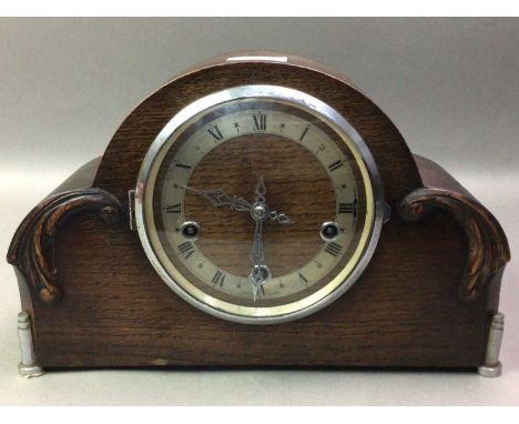 OAK CASED MANTEL CLOCK WITH A SPELTER FIGURE AND A BRASS JARDINIERE the clock with circular dial and eight day movement 22cm 