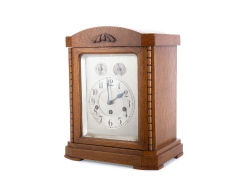GERMAN OAK MANTEL CLOCK EARLY 20TH CENTURY with three day eight train movement by Junghans, striking on four gongs, the silve