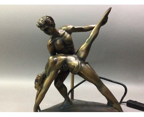 GILT RESIN FIGURAL TABLE LAMP AND ANOTHER the figural lamp modelled as two dancers, the pillar lamp in green lacquer and gilt