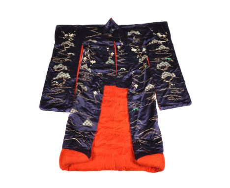 A Japanese Furisode Silk Kimono, the midnight blue ground embroidered in colours and gold with minogame, cranes and pine (all