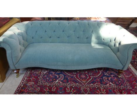 A Victorian button back sofa re upholstered in a blue fabric