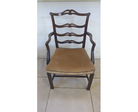 A 19th century mahogany ladder back elbow chair Condition report: With old repairs 