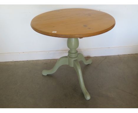 A tripod pine table with lift up top. Polished top and painted base