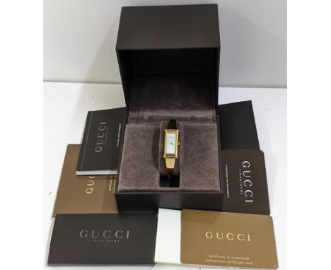 A boxed Gucci gold plated bangle wristwatch with a mother of pearl dialLocation: 