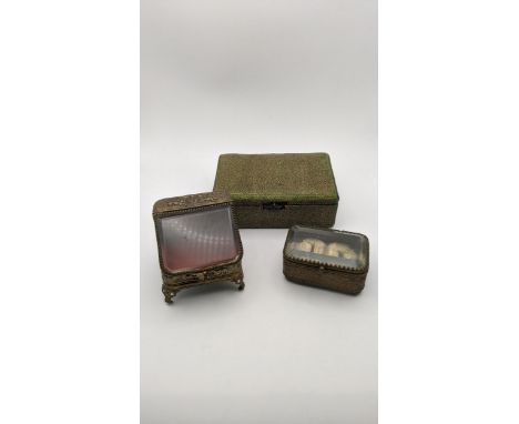 A Shagreen box having a later silver inkwell set in the hinged lid, together with two gilt metal French embossed jewellery ca