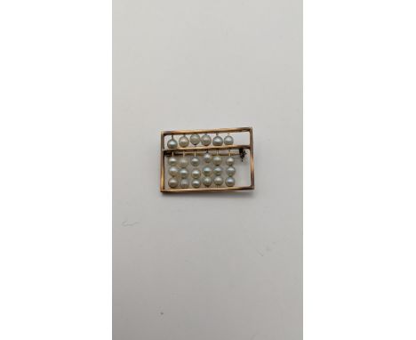 A 10ct gold and pearl bar brooch fashioned as an abacus 4.9gLocation: 