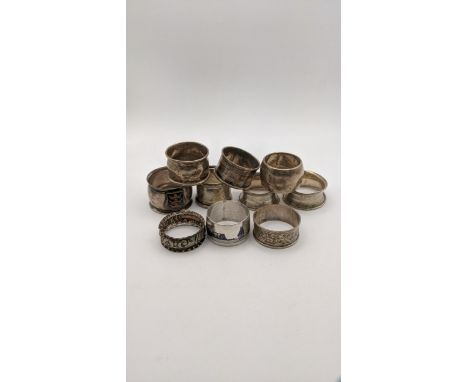 A variety of silver and white metal napkin rings to include a Niello napkin ring, a floral embossed napkin ring and others, t