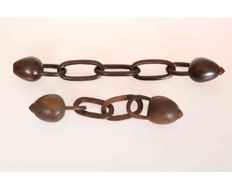 FOUR ZULU OR TSONGA CARVED HARDWOOD SNUFF CONTAINERS, probably 19th Century, two united by chain-like wooden links (one conta