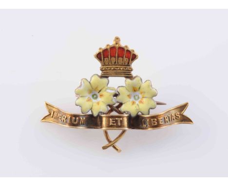 A PRIMROSE LEAGUE ENAMEL SET BROOCH, the two yellow enamelled primrose flowers set beneath a red enamelled crown, and above a