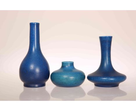 A GROUP OF THREE PILKINGTONS ROYAL LANCASTRIAN MATT BLUE LUSTRE VASES, the first of slender baluster form, the second of squa