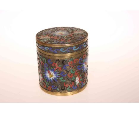 A CHINESE CLOISONNE ENAMEL BOX AND COVER, cylindrical, decorated with lotus flower and scrolling foliage. 10cm high