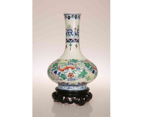 A CHINESE PORCELAIN VASE, of baluster form with elongated neck, painted in polychrome enamels with fruit and bats amidst foli