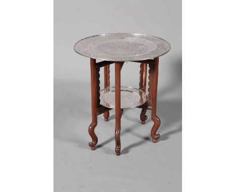 A CHINESE SILVERED METAL TWO TIER TRAY TABLE, mid-20th century, the larger circular tray engraved and chased with dragons, en