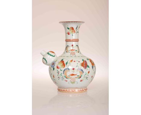 A CHINESE PORCELAIN KENDI OR WINE PITCHER, enamel painted in the famille rose palette with crests and flowers. 24cm