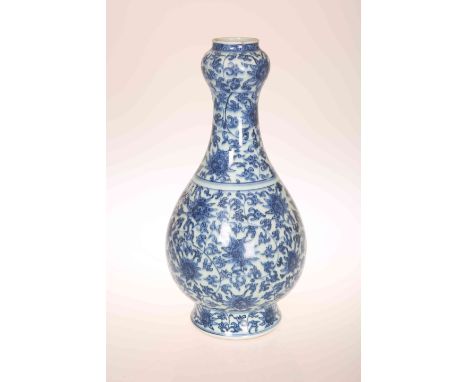 A CHINESE BLUE AND WHITE PORCELAIN VASE, of baluster form, with "garlic" neck, painted with stylised flowers and foliage and 