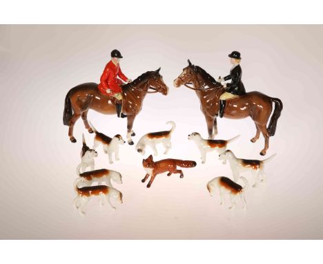 A BESWICK POTTERY HUNTING GROUP, comprising huntsman in a red coat and huntswoman in a black coat, each on a bay horse, with 