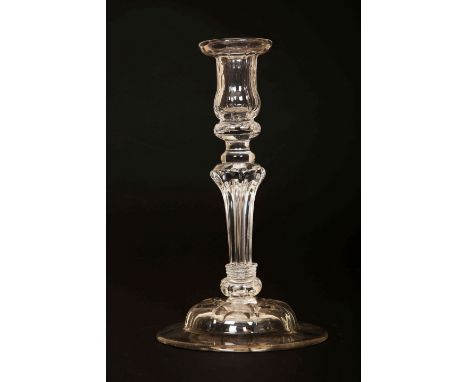 A GEORGE III GLASS CANDLESTICK, CIRCA 1760, the moulded urn-form sconce raised on a tapering fluting standard over a domed ci