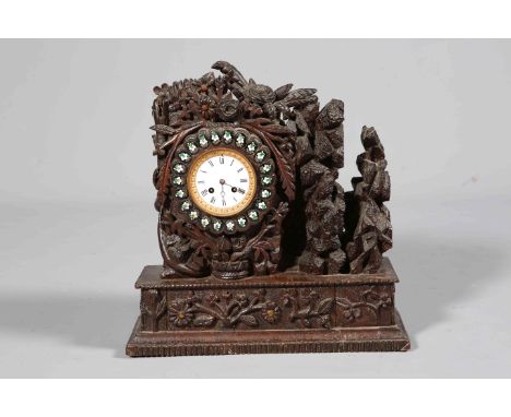AN UNUSUAL CARVED OAK MANTEL CLOCK, 19TH CENTURY, boldly carved with foliage, white enamel dial with Roman numerals, two-trai