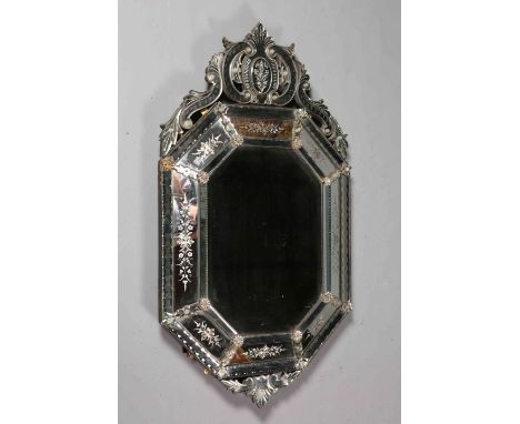 A VENETIAN WALL MIRROR, LATE 19TH CENTURY, the scrolling surmount above a central octagonal bevelled mirror plate within a co
