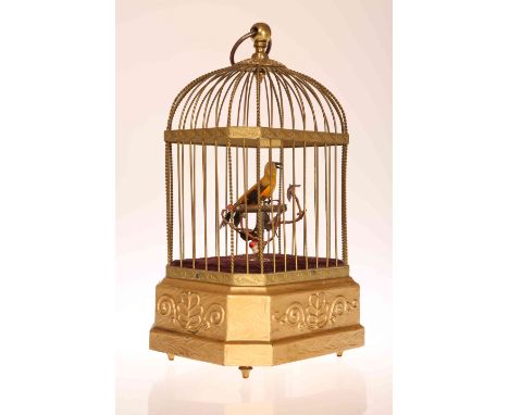 A SINGING BIRD AUTOMATON, LATE 19TH/EARLY 20TH CENTURY, in gilt wirework cage, clockwork movement to base. 28cm high