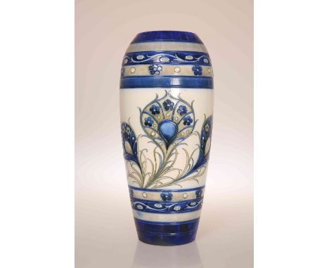 WILLIAM MOORCROFT (1872-1945)A 1930'S SALT GLAZED VASE, of ovoid form, tubelined and hand painted with peacock feathers, blue