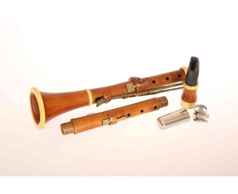 A 19th CENTURY IVORY MOUNTED BOXWOOD CLARINET, GOULDING & CO., in four sections, each with stamped maker's mark. Length 59cm