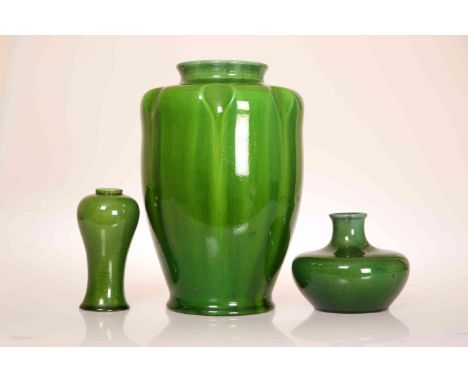 THREE PILKINGTONS ROYAL LANCASTRIAN GREEN-GLAZED VASES, early 20th Century: the largest of hipped baluster form with dimpled 