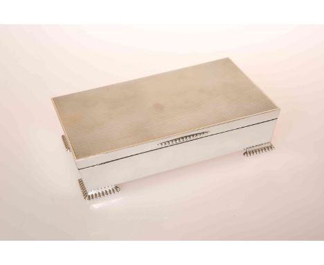 A STYLISH SILVER CIGARETTE BOX, ADIE BROTHERS, BIRMINGHAM 1958, of tapering rectangular form, with engine turned cover and ra