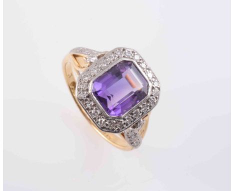 AN AMETHYST AND DIAMOND RING, circa 1890-1900, the cut-cornered square cut amethyst collet set within a surround of twenty-tw