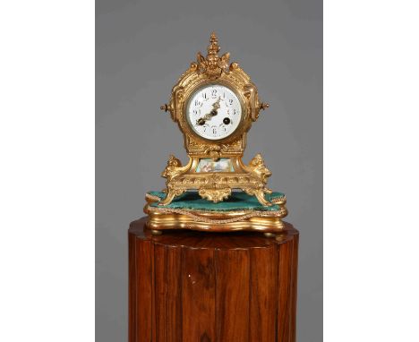 A FRENCH GILT-METAL MANTEL CLOCK, LATE 19TH CENTURY, the white enamel dial with Arabic numerals and floral swags, the case wi