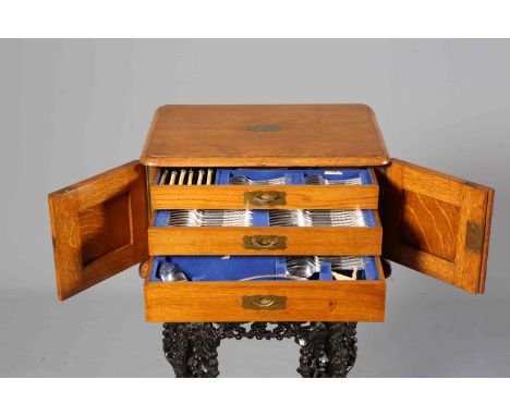 A GOOD VICTORIAN OAK CASED CANTEEN OF SILVER-PLATED CUTLERY, twelve place settings, the case with three drawers. Width of cas