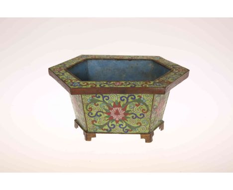 A SMALL CHINESE CLOISONNE ENAMEL JARDINIERE, of hexagonal form, decorated with foliate patterns against a green ground, on sh