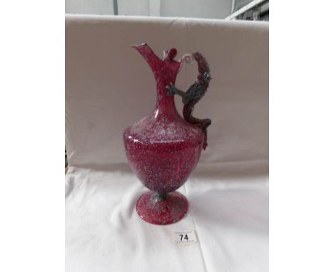 An early cranberry glass ewer with blue enamel mottled decoration and dragon handle (handle a/f)
