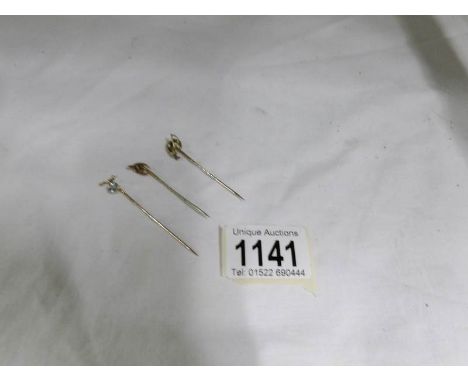 3 19th century gold stick pins, 1 set aquamarine, 1 whip and horseshoe and the other a wishbone with Isle of Man emblem
