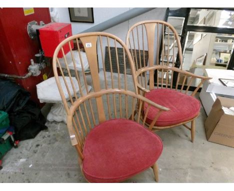 A pair of Ercol stick back armchairs