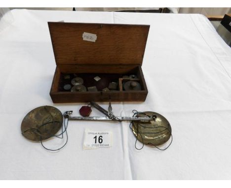 A cased set of Victorian hand balance scales with some weights