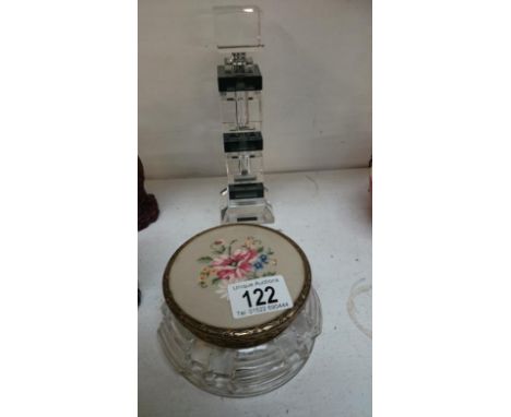 A perfume bottle and a trinket pot