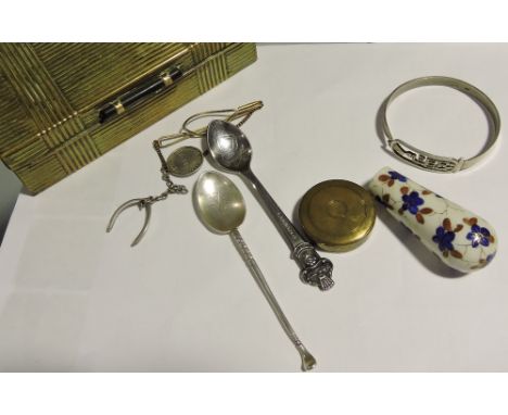 An Art Deco brass cigarette box containing a brass cased pocket compass, a Merrythought wishbone chain pendant, silver golfin