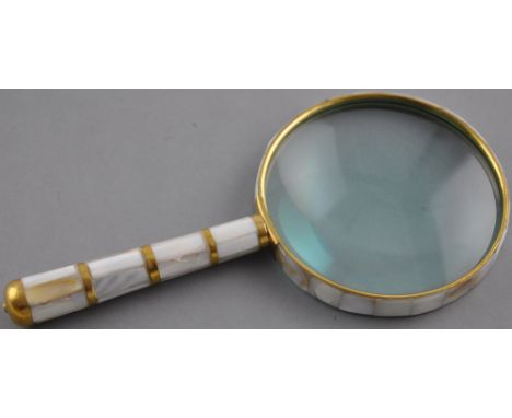 A Victorian style brass table magnifier with mother of pearl decoration