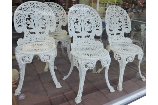 A Victorian style circular white painted garden table and 4 matching