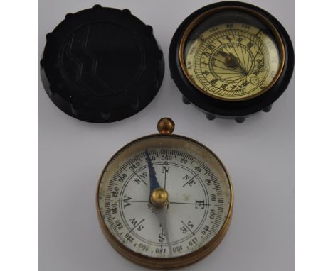 A 20th century brown bakelite cased pocket sundial, D. 3cm, together with a compass, (2).
