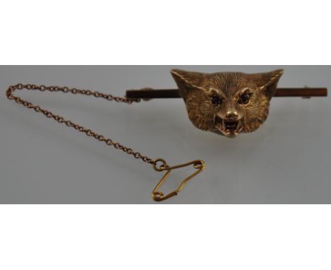 A 9ct gold bar brooch, modelled as a fox head, with ruby eyes, 12.5g. 
