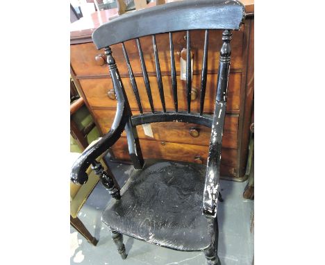 A Victorian elm and beech comb back Windsor armchair on turned baluster legs (later painted black). 