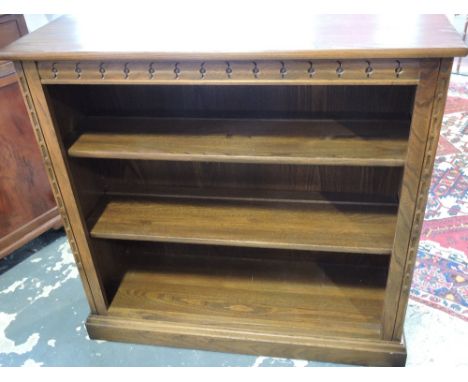 An Ercol elm open bookcase with adjustable shelves on plinth foot, w:96cm